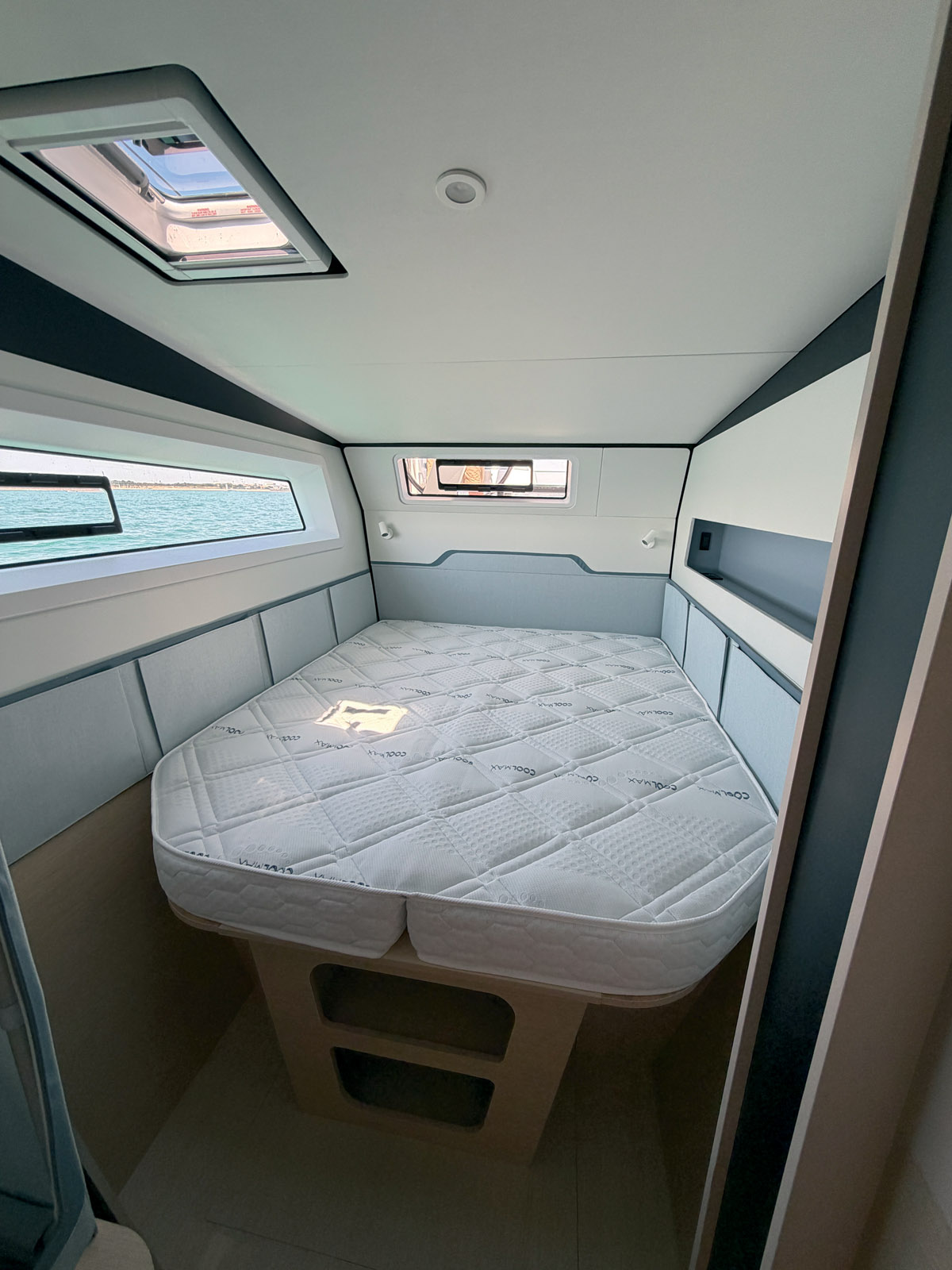The aft cabins (here, the guest cabin in the  starboard hull) feature a large berth measuring 63 x 78” (1.6 × 1.98 m). Headroom is 6’5” (1.95 m).