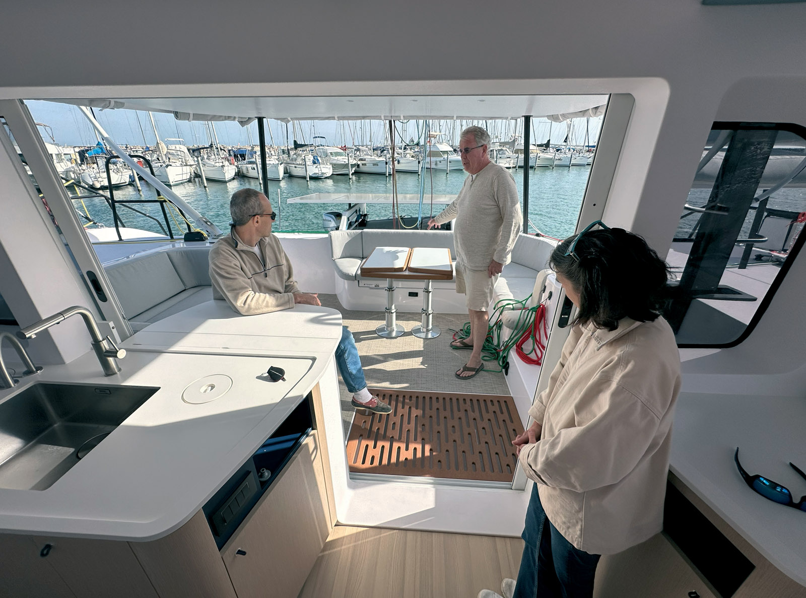The island connecting the L-shaped galley to the cockpit creates a seamless flow between the interior and exterior living spaces. A fold-down table further enhances this “inside-outside” effect. Note the ample storage options.