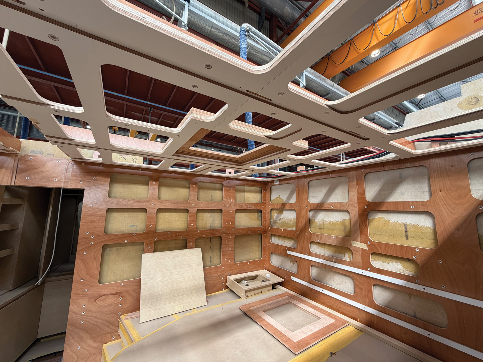 Interior joinery is assembled before the deck is bonded to the hull.
