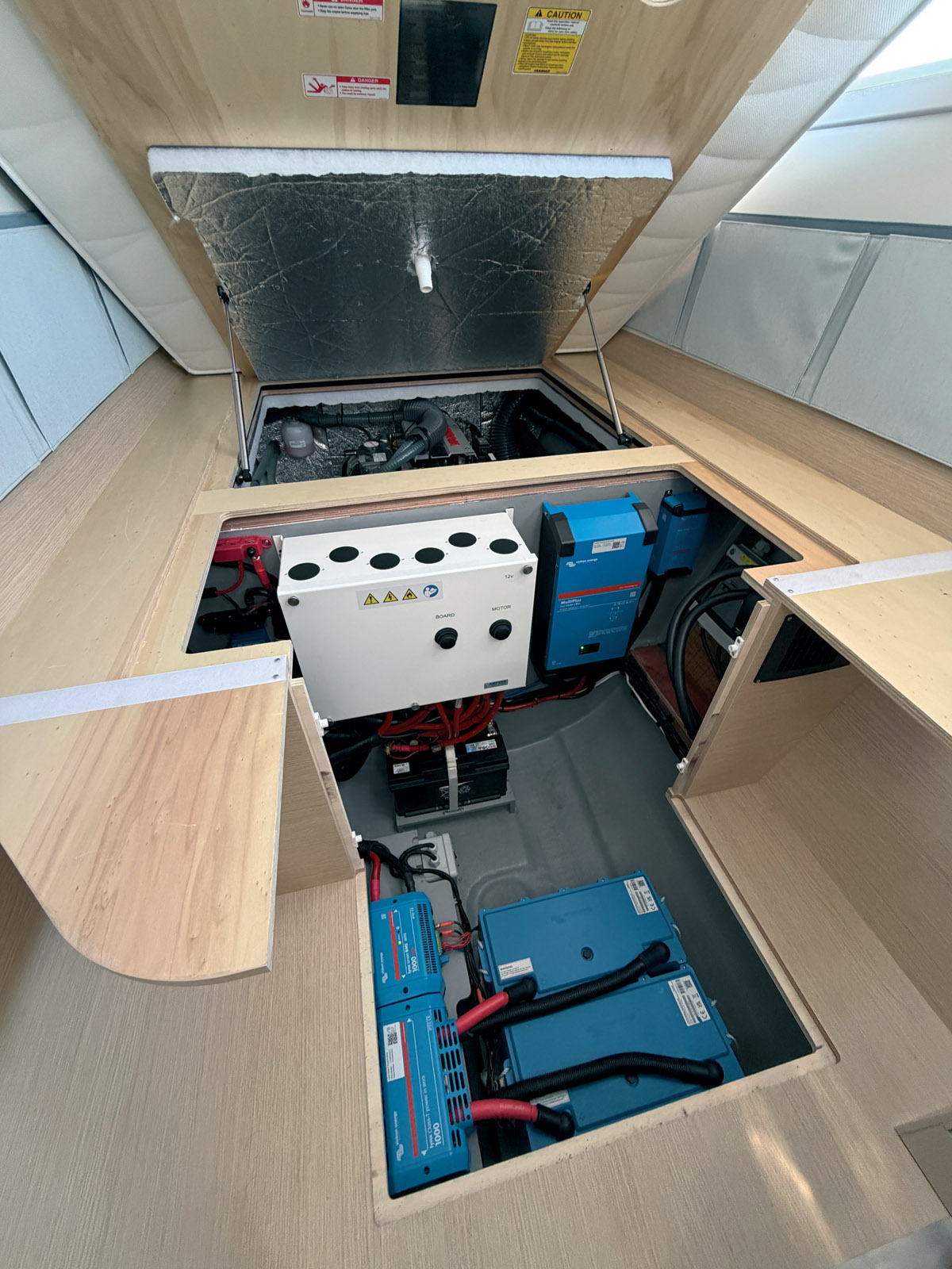 The engines were installed through hatches in the cockpit but have been moved forward under the berths, which helps with weight centering. Technical access points were designed to facilitate routine maintenance and future upgrades to the catamaran - one of the founding principles of the ReShape concept.