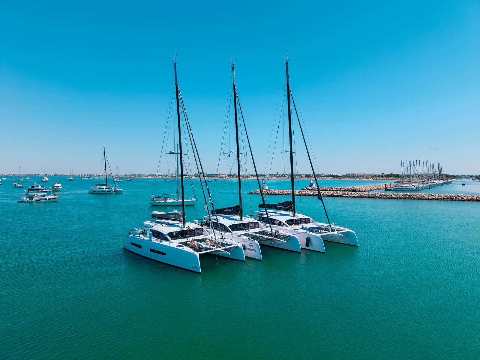 The Outremer 48, 52, and 55 gathered behind Le Bancaou, a sandbar off Port Camargue. They all share a common aesthetic signature and design philosophy.