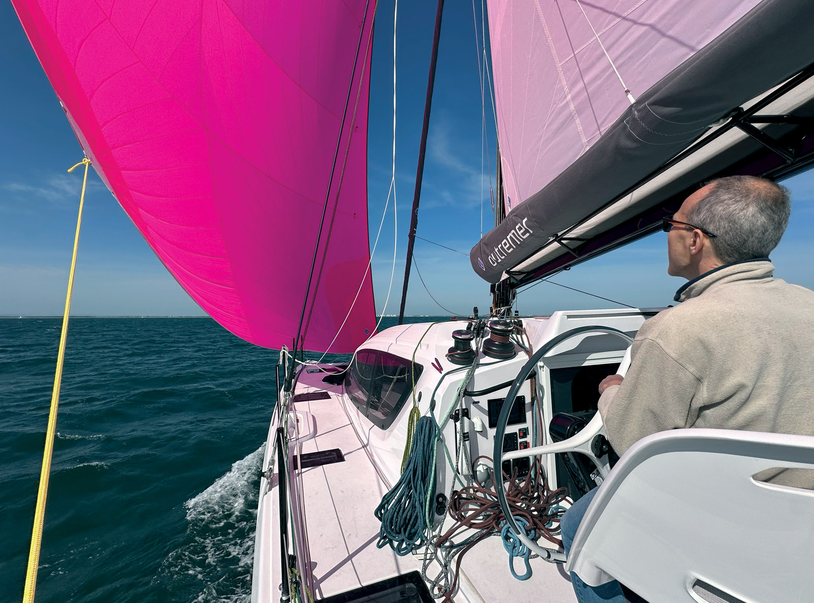 Under asymmetric spinnaker, the GPS reads nearly 15 knots in  18-knot winds. The sock makes it just as easy to hoist as it is to lower  this 1,937-square-foot (180 m²) sail. 