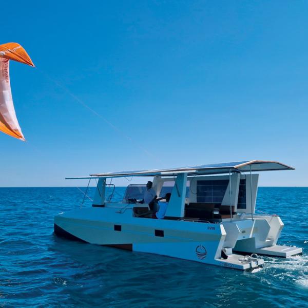 The M.9, here being tested with a 10 m² (108 sq ft) LibertyKite sail, is one of  the very first multihulls to be completely fossil fuel-free.