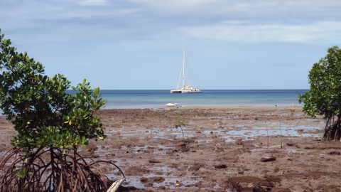 Jangada, anchored off the island of Pana Wina in the big Tagula lagoon, in the Louisiades 