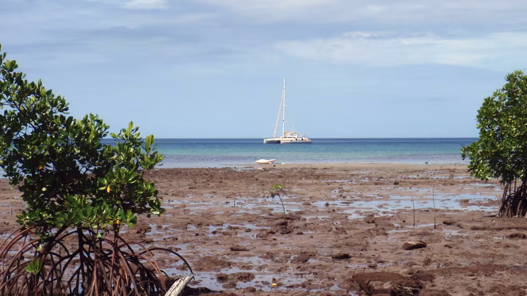 Jangada, anchored off the island of Pana Wina in the big Tagula lagoon, in the Louisiades 